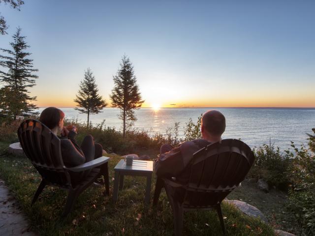 couple sitting by lake at sunset